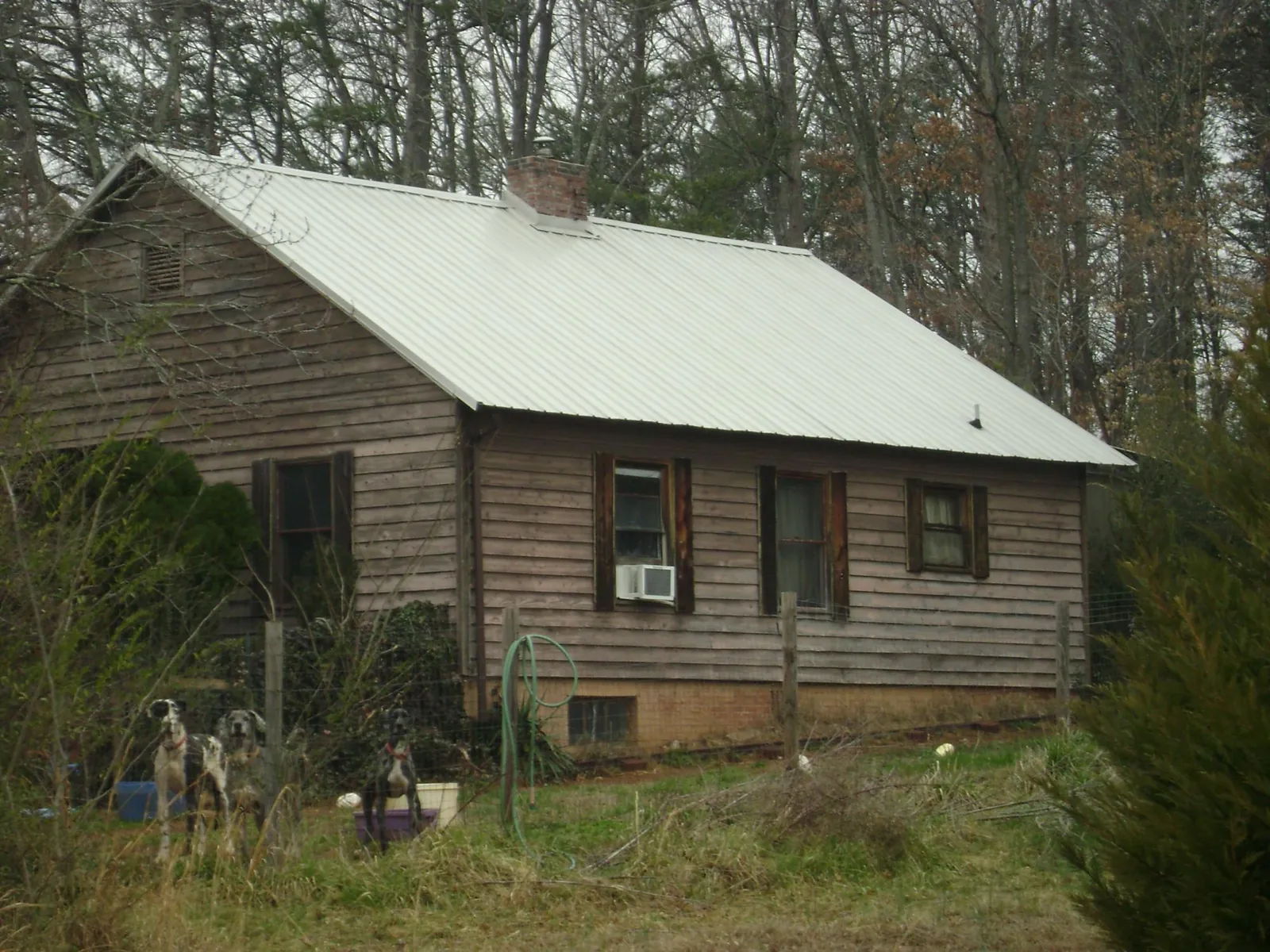 White metal roof on an old wood sided farmhouse, from a Metal Roof Installation job in Benge